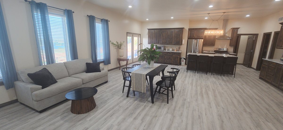The open living, dining and kitchen area inside the house