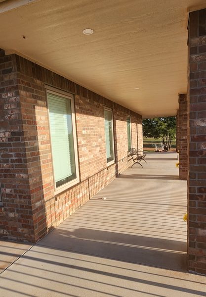 Covered porch along the brick exterior