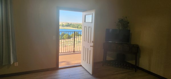 A door out to the balcony and the lake